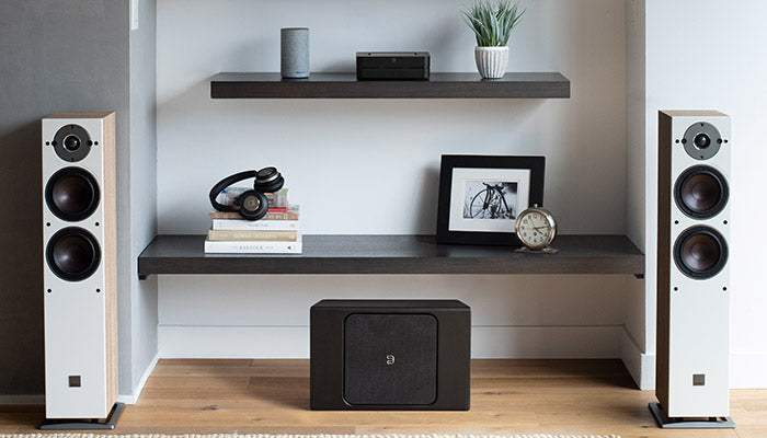 Bluesound Powernode black front on shelf with speakers view